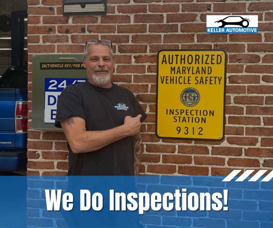 Auto repair shop owner pointing at a large yellow sign that says Authorized Maryland Vehicle Safety Inspection Station 9312